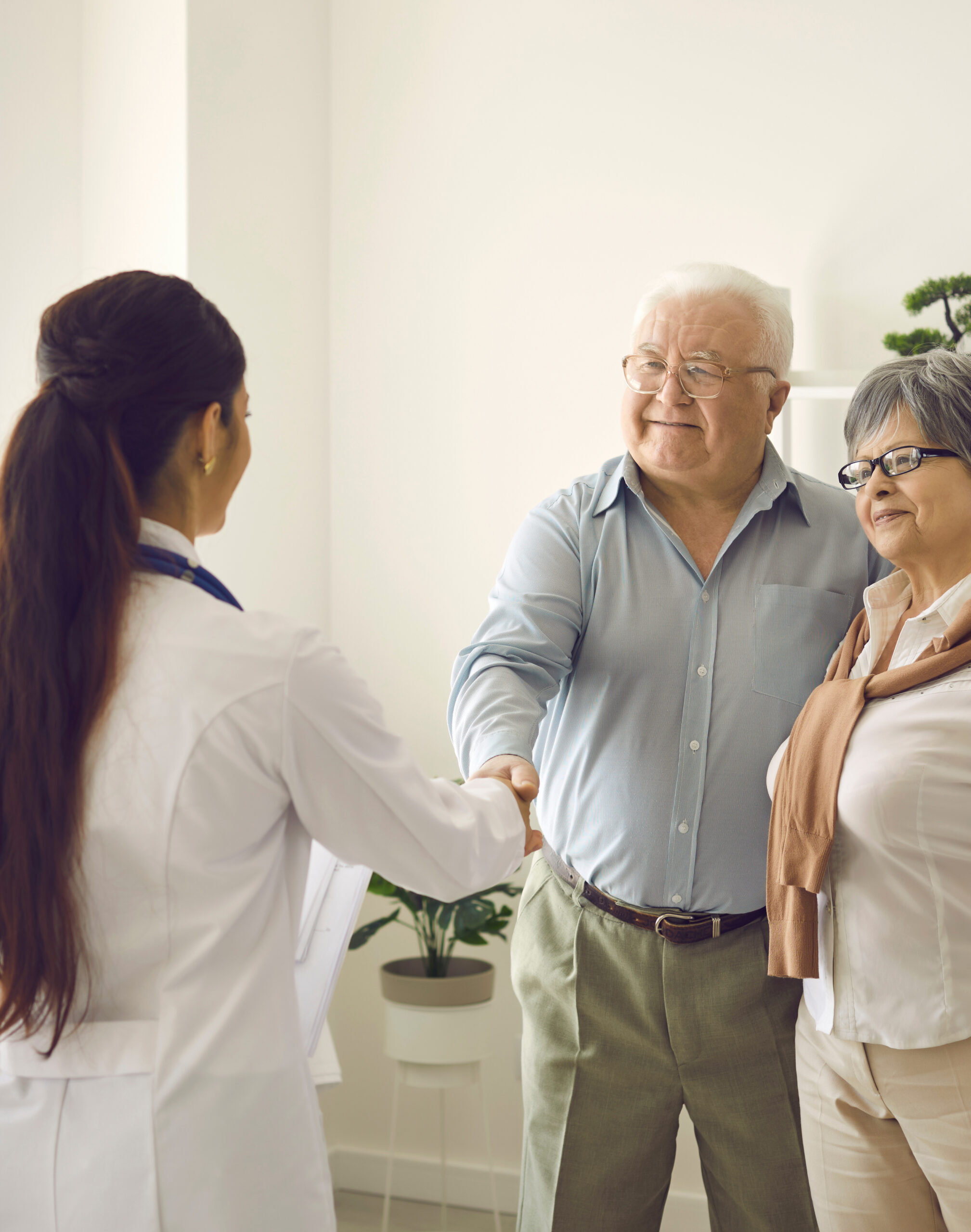 Doctor,Welcomes,Or,Congratulates,Couple,Of,Patients,On,Successful,Recovery.