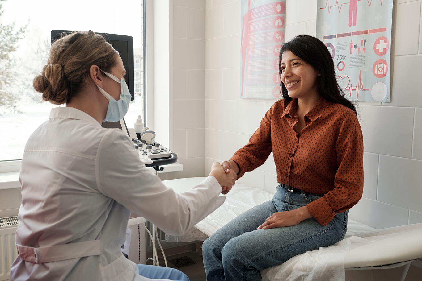 Female,Clinician,Shaking,Hand,Of,Young,Happy,Hispanic,Patient,Sitting