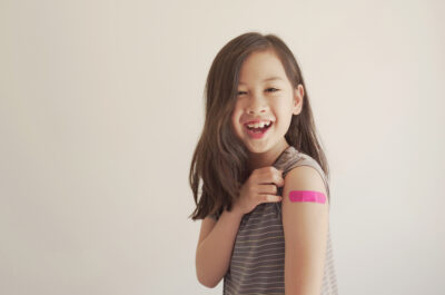 Mixed,Asian,Young,Girl,Showing,Her,Arm,With,Pink,Bandage